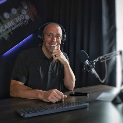 Scott E. Burgess in podcast studio prepared for a virtual call, bringing dynamic health and performance expertise as a virtual speaker.
