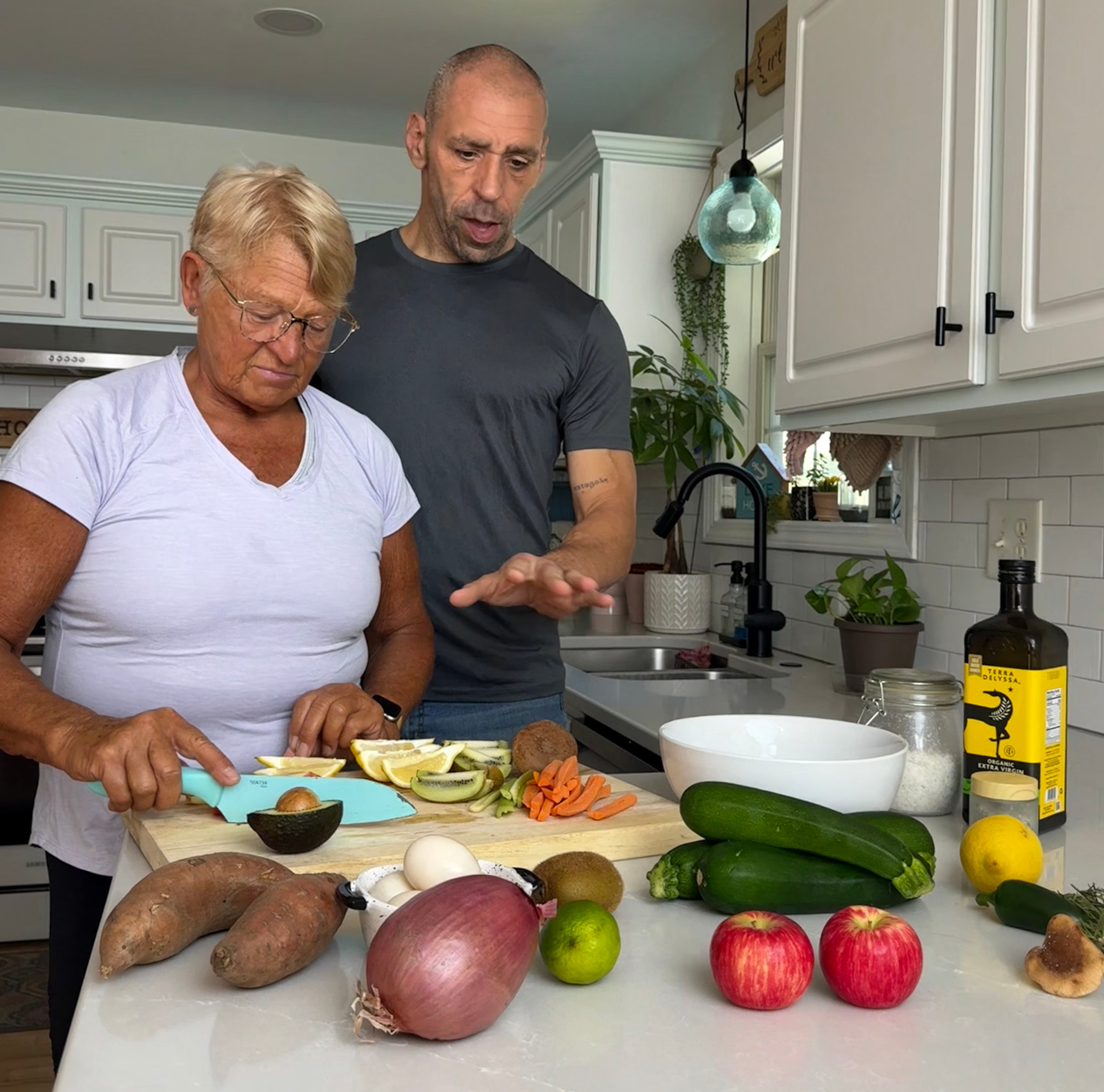 Scott E. Burgess guiding a client in whole food meal prep, part of the BALANCED approach to natural healing, energy, and long-term health.