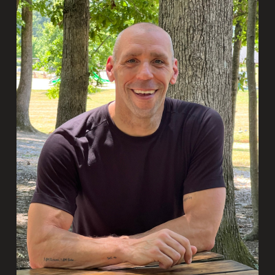 Scott E. Burgess, RTT practitioner in Oak Ridge, NC, smiling and welcoming clients for in-person sessions focused on healing and transformation.